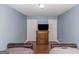 Bedroom with two twin beds and wood dresser at 275 Bramble Bush Trl, Covington, GA 30014