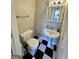 Clean bathroom with pedestal sink and black and white checkered floor at 470 Harris Rockmore Loop, Covington, GA 30014