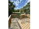 Wooden deck overlooks backyard with wooded area beyond at 470 Harris Rockmore Loop, Covington, GA 30014