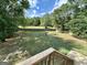 Wooden deck overlooks backyard with firepit and wooded area at 470 Harris Rockmore Loop, Covington, GA 30014