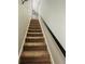 Carpeted stairs with dark wood handrail at 470 Harris Rockmore Loop, Covington, GA 30014