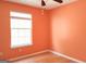 Simple bedroom featuring hardwood floors, a window, and neutral wall paint at 5738 Antelope Trl, Atlanta, GA 30349