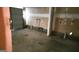 An empty garage with pipes, wiring, and a roll-up door at 5738 Antelope Trl, Atlanta, GA 30349