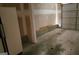 An empty garage with a refrigerator and a roll-up door at 5738 Antelope Trl, Atlanta, GA 30349