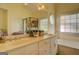 Bathroom featuring double sinks, natural light, and vanity mirror at 557 Arrowhead Cir, Rutledge, GA 30663