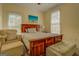 Bedroom with a wooden bed, two windows, and a comfy armchair at 557 Arrowhead Cir, Rutledge, GA 30663