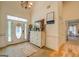 Bright entryway with tiled floors and whitewashed dresser at 557 Arrowhead Cir, Rutledge, GA 30663