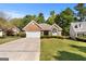 Brick ranch home with attached garage and landscaped lawn at 1152 Strath Clyde Way, Mcdonough, GA 30253