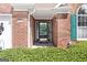 Brick house with a green door and well-manicured shrubs at 1152 Strath Clyde Way, Mcdonough, GA 30253