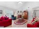 Vaulted ceiling living room with red sofas and a fireplace at 1152 Strath Clyde Way, Mcdonough, GA 30253