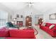 Living room with vaulted ceiling, red sofas, and fireplace at 1152 Strath Clyde Way, Mcdonough, GA 30253