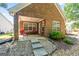 Brick patio with red chairs and table, steps leading to the yard at 1152 Strath Clyde Way, Mcdonough, GA 30253