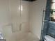 A bathroom with a bathtub, toilet and shelving needing some repair at 5303 Kemper Pl, Stone Mountain, GA 30088