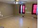 Spacious bedroom with light wood floors and red curtains at 5303 Kemper Pl, Stone Mountain, GA 30088