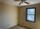 A bedroom with a window and ceiling fan needing some repair at 5303 Kemper Pl, Stone Mountain, GA 30088