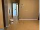 A hallway with light brown laminate flooring and an interior door at 5303 Kemper Pl, Stone Mountain, GA 30088