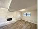 Finished basement recreation room with fireplace and wood-look flooring at 3786 Glen Mora Dr, Decatur, GA 30032