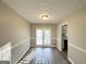 Bright dining room with hardwood floors and French doors at 3786 Glen Mora Dr, Decatur, GA 30032