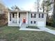 Newly renovated gray house with red door and landscaped yard at 3786 Glen Mora Dr, Decatur, GA 30032