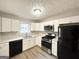 Modern kitchen with white cabinets and stainless steel appliances at 3786 Glen Mora Dr, Decatur, GA 30032