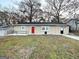 Charming ranch home with red front door and manicured lawn at 2920 Springside Se Pl, Atlanta, GA 30354