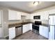 Updated kitchen with white cabinets and stainless steel appliances at 3205 Cadiz Cir, South Fulton, GA 30349