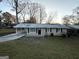 Charming ranch home with a covered porch and spacious yard at 3226 Browns Mill Se Rd, Atlanta, GA 30354