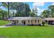 Ranch style home with a covered porch and well-maintained lawn at 3226 Browns Mill Se Rd, Atlanta, GA 30354