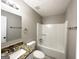 Updated bathroom with granite vanity and tub shower at 220 Mountain View Cir, Covington, GA 30016