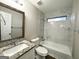 Clean bathroom with granite vanity, white bathtub, and marble-look tile at 3951 Wabash Ln, Ellenwood, GA 30294