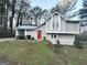 Two-story house with red door, light beige siding, and green lawn at 3951 Wabash Ln, Ellenwood, GA 30294