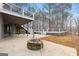 Large deck and patio area with fire pit, steps to lower deck, and wooded view at 123 Line Creek Way, Sharpsburg, GA 30277