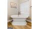 Bathroom with freestanding tub and window at 123 Line Creek Way, Sharpsburg, GA 30277