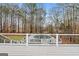 Deck view of backyard with pool and wooded area at 123 Line Creek Way, Sharpsburg, GA 30277