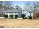 Gray house with blue door, stone steps, and landscaping at 123 Line Creek Way, Sharpsburg, GA 30277