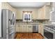 Modern kitchen with stainless steel appliances and granite countertops at 123 Line Creek Way, Sharpsburg, GA 30277