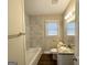 Updated bathroom with marble tile and granite vanity at 2490 Habersham Dr, Decatur, GA 30032