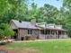 Ranch-style brick home with a spacious yard and porch at 930 Singley Dr, Locust Grove, GA 30248