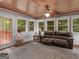 Bright sunroom with wood ceiling, window seat, and access to exterior at 930 Singley Dr, Locust Grove, GA 30248