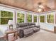 Relaxing sunroom with wood ceiling, lots of windows, and comfortable seating at 930 Singley Dr, Locust Grove, GA 30248