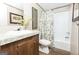 Clean bathroom with a floral shower curtain and wood vanity at 58 Pinewood Dr, Carrollton, GA 30116