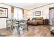 Light and airy dining area with a rustic farmhouse table and chairs at 58 Pinewood Dr, Carrollton, GA 30116