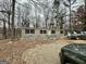 Tan single-wide mobile home with black shutters, surrounded by trees at 58 Pinewood Dr, Carrollton, GA 30116