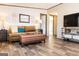 Comfortable living room with brown couch and leather ottoman at 58 Pinewood Dr, Carrollton, GA 30116