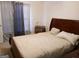 Bedroom with wooden sleigh bed and gray curtains at 635 Watson Bay, Stone Mountain, GA 30087