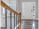 Two-story entryway with wooden railings and neutral-toned flooring at 5585 Dendy Trc, Fairburn, GA 30213