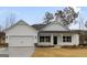 Newly constructed home with white siding, a two-car garage, and landscaping at 8950 Callaway Drive, Winston, GA 30187