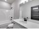 Bathroom boasts a white vanity, quartz countertop, and a large mirror at 115 Camilla Drive, Carrollton, GA 30116