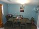 Dining area with a table and chairs, wall art, and light teal walls at 1434 Butler St, Jonesboro, GA 30236