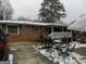Brick ranch home with a covered porch, patio, and spacious yard at 1434 Butler St, Jonesboro, GA 30236